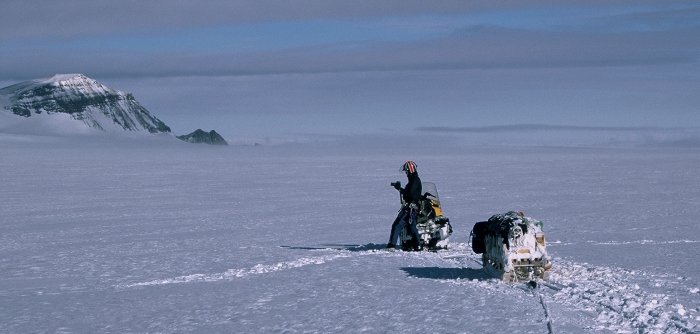 Jon Bursnall on the lead skidoo and sledge, during my second winter trip, heading north on the Fuchs Ice Piedmont on the eastern side of Adelaide Island.