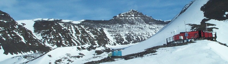 The hut at Fossil Bluff fuel depot on Alexander Island. The hill directly above the hut is called Drune and the one just to the left is called Pyramid.